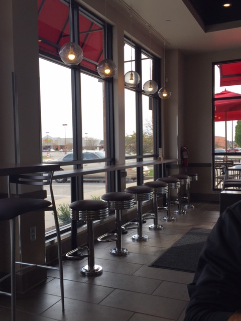 Bar stool seating for an outlook of the shopping plaza for customers. Photo Credit: Sarah Goetze